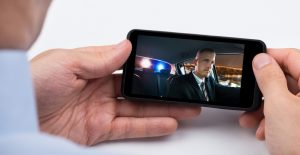 Close-up Of Person Watching Video On Mobile Phone